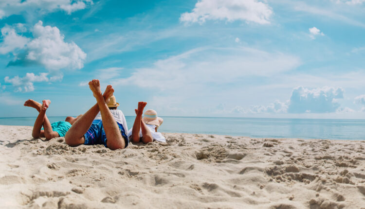 father with son and daughter relax on beach vacation, family at sea, panorama